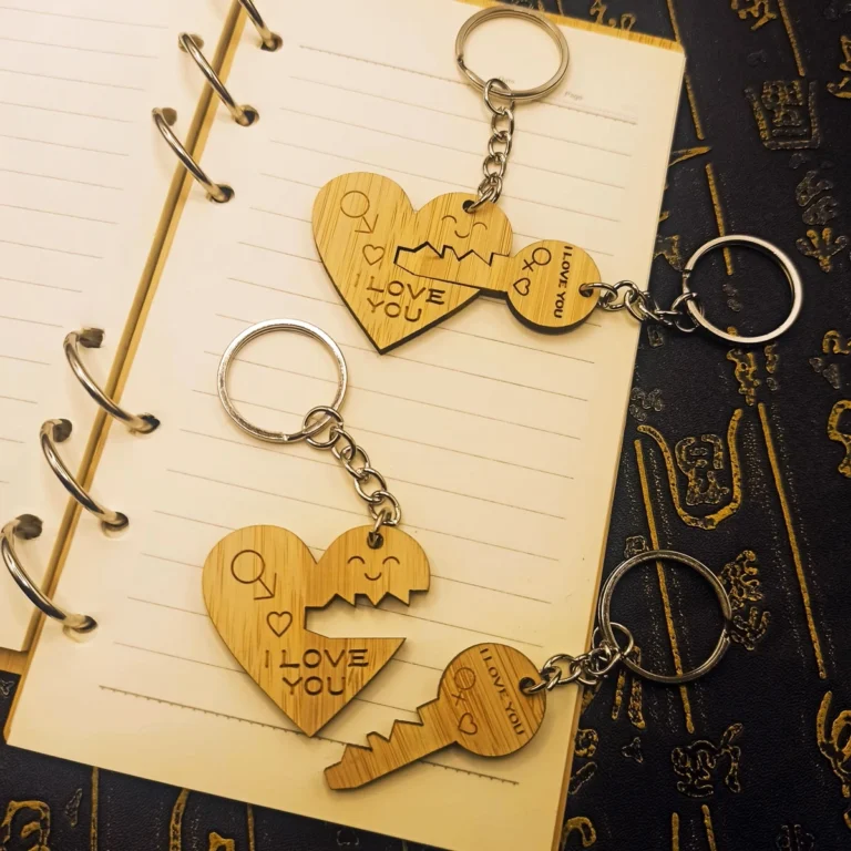 Custom Various wooden couple keychains with engraved LOVE and heart designs, displayed on a bamboo board - CustomBlitz.com